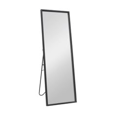 a mirror that is standing up against a wall