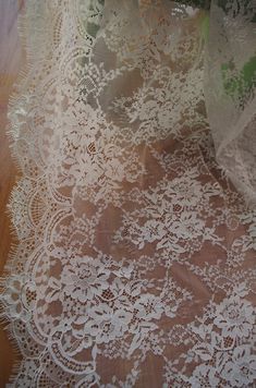 off white Chantilly lace fabric, French chantilly lace, retro wedding lace fabric with scalloped bor White Lace Dress With Lace Patchwork, Off White Lace Dress For Wedding, White Scalloped Lace Dress, Off White Lace Trim Wedding Dress, White Lace Dress With Scalloped Details, White Lace Dress With Contrast Lace For Wedding, Cream Lace Dress With Delicate Details, Cream Lace Dress With Scalloped Details, Cream Lace Dress With Lace Patchwork