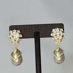 These Beautiful Bridal Earrings Will Complete Your Look On Your Special Day. They Feature The Timeless Elegance Of A Teardrop Champagne Pearl Encrusted With Simulated Diamonds Set In Champagne Gold Hanging From A Beautiful Cluster Of Simulated Diamonds At The Top. The Post Is Made Of Pure 925 Sterling Silver. Glamorous Teardrop Pearl Earrings For Formal Occasions, Glamorous Formal Clip-on Bridal Earrings, Elegant Jeweled Teardrop Dangle Earrings, Formal Teardrop Crystal Clip-on Earrings, Teardrop Crystal Clip-on Earrings For Formal Occasions, Elegant Formal Clip-on Crystal Earrings, Formal Drop Pearl Crystal Earrings, Elegant Clip-on Teardrop Earrings For Party, Elegant Clip-on Teardrop Party Earrings