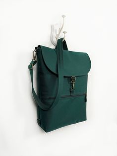 "Vegan Convertible Backpack, Women Teal Backpack, Waterproof Cross Body Bag, Minimalist Shoulder Bag, Green Functional Backpack, Laptop Bag The perfect vegan minimalist convertible backpack that balances a professional and casual look. Made from the highest waterproof of fabric and with a pleasant-touch canvas lining, this bag is guaranteed long life. Ideal for work, travel, and everything in between. Available in several sizes, just choose the right one for you. FEATURES - waterproof outer - ca Functional Green Crossbody Backpack, Practical Crossbody Backpack For Daily Use, Functional Green Satchel Backpack, Green Shoulder Bag With Laptop Sleeve For Everyday Use, Green Crossbody Backpack With Adjustable Strap, Green Backpack With Zipper Pocket For Daily Use, Green Tote Backpack With Zipper Closure, Green Satchel Backpack With Zipper Pocket, Green Standard Backpack Laptop Bag For Everyday Use