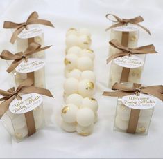 small candles with brown bows and labels on them