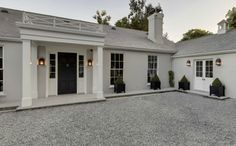 a large white house with black doors and windows