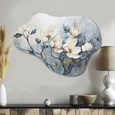 a white flower on a blue background is mounted to the wall above a fireplace mantel