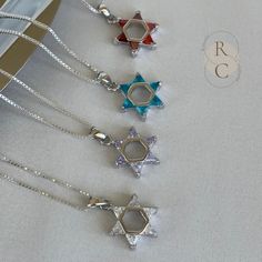 Discover the elegance of this silver Magen David necklace adorned with colored stones. A symbol of protection and spirituality, this exquisite Star of David pendant will captivate all eyes. From purple, crystal clear to deep orange, this pendant accurately represents the Star of David. You will love wearing it with a fresh outfit for any occasion. Lastly, it makes a perfect gift to give or indulge yourself. ADDITIONAL DETAILS D E T A I L S: * MATERIAL: 925 Sterling Silver * PENDANT SIZE: 15mm x Silver Star Of David Necklace With Gemstone, Silver Star Of David Birthstone Jewelry, Silver Star Of David Jewelry With Birthstone, Silver Star Of David Necklace For Hanukkah, White Gold Star Of David Spiritual Jewelry, Spiritual White Gold Star Of David Jewelry, Spiritual Star Of David White Gold Jewelry, Hanukkah Sterling Silver Silver Necklace, Silver Sterling Silver Necklace For Hanukkah