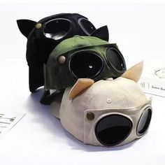 two stuffed animals wearing goggles on top of each other