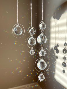 the sun shines through the window and reflects on the glass beads hanging from the ceiling