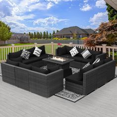 an outdoor patio with black wicker furniture