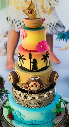 a multi - tiered cake with an elaborate topper and decorative decorations on it