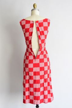 "Vintage 1950s cotton daydress. Red check and white striped check design. Scoop collar, darted bust, 2\" shoulder straps, nipped waist, sarong-like detail at hip. Back metal zipper closure. State of garment | excellent. Measurements ✂--- best fit | XXS bust | 30 \" shoulders | not specified shoulder to waist | 13.5\" sleeves | not specified waist | 22 \" hips | up to 38\" total length (shoulder to hem) | 38\" tag | none present ★★Visit The Shop★★ http://www.etsy.com/shop/seaofvintage ➸ Find the 1950s Gingham Cotton Dresses, 1950s Plaid Summer Dresses, 1950s Style Plaid Summer Dresses, Vintage Black Cocktail Dress, Wine Dress, Peach Dress, Cheque Design, Paisley Dress, Black Cocktail Dress