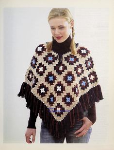 a woman is wearing a crocheted shawl