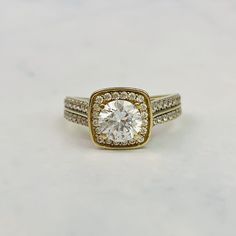 An engagement ring with brilliant clear cubic zirconia stones in 9K yellow gold. The ring features a round brilliant cut stone in the center with smaller stones set around him in a halo, with two more rows of paved stones on each shoulder.  The ring is in excellent vintage condition. Ring is size 6 US and resizable. It has multiple markings inside the band including 375 but are quite faint. Please inquire for a quote. Further details are as follows: Stone: Round cut CZ stone, several round cut s Timeless Gold Halo Ring With Cubic Zirconia, Timeless Gold Cluster Ring With Halo Setting, Round Cluster Ring In White Topaz With Brilliant Cut, Gold Timeless Cubic Zirconia Halo Ring, Gold Cluster Ring, Dazzling Style, Gold Cluster Ring With Dazzling Style, Yellow Gold Cluster Ring With Center Stone, White Topaz Cluster Ring With Brilliant Cut, Dazzling Gold Cluster Ring With Center Stone