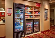 an image of a grocery store with refrigerators full of food and drinks in it