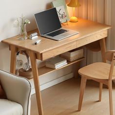 a laptop computer sitting on top of a wooden desk next to a chair and lamp