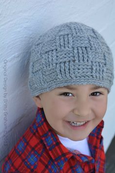 a young boy wearing a gray knitted hat