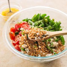 a glass bowl filled with rice and vegetables