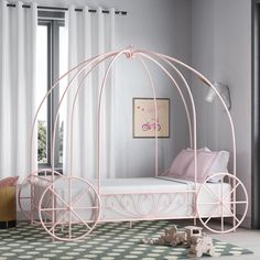 a bedroom with a pink canopy bed in the corner