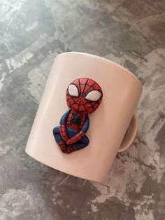 a coffee cup with a spider man on it