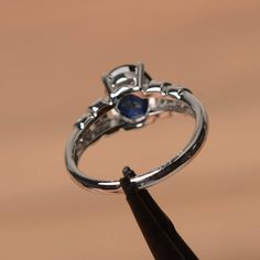 It is a lab sapphire ring. The main stone is 7 mm*9 mm oval cut.weight about 2.32 carats. The basic metal is sterling silver and plated with rhodium. To change the metal to a solid gold (white/rose) or platinum is also available, please ask for a quotation if you want. You can also go to my shop Home for more elegant rings: https://www.etsy.com/shop/godjewelry?ref=hdr_shop_menu Sapphire is the September birthstone. More sapphire rings: https://www.etsy.com/shop/godjewelry?section_id=20715031 Cus Oval Sapphire Promise Ring In 14k White Gold, Silver Oval Sapphire Birthstone Ring, Silver Oval Sapphire Ring, Oval Sapphire Jewelry In 14k White Gold, 14k White Gold Sapphire Jewelry In Oval Shape, Oval Lab-created Sapphire Birthstone Jewelry, Oval Birthstone Jewelry With Lab-created Sapphire, Silver Sapphire Ring With Oval Cabochon, Silver Sapphire Oval Cabochon Ring