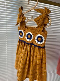 a yellow dress hanging on a clothes rack