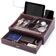 an electronic device and other items in a brown leather case on top of each other