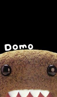 a close up of a stuffed animal with the words domo on it's face