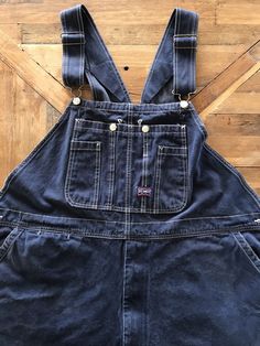 "There's no interior tags on these ol' Big Smith overalls and I provided measurements in the photos for an accurate fit. They best fit a XXL and can be adjusted into as long as 64\" In total length. They appear to have been worn cuffed for a long period of time as there's some distress at the lower legs. They're a deep indigo denim and are super soft, durable cotton with all the original hardware in tact and functioning shoulder adjustable straps and zip fly. These are well worn and have tons of character, please refer to the photos for an accurate reflection of the condition ✨(4)" Dark Wash Relaxed Fit Shortalls With Pockets, Relaxed Fit Dark Wash Shortalls With Pockets, Distressed Dark Wash Cotton Overalls, Distressed Cotton Overalls In Dark Wash, Dark Wash Distressed Cotton Overalls, Medium Wash Distressed Denim Jumpsuit, Denim Blue Washed Utility Overalls, Washed Blue Denim Utility Overalls, Utility Denim Overalls In Washed Blue