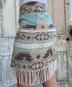 This beautiful Sonora Skirt is made of 20% Wool, 50% Acrylic, 25% Polyester, 5% Other Fabric 17" length, plus 3” Fringe Measured laying flat across the top hem: Small - 14" Medium - 16.75" Large - 17.5" XLarge - 19" Made in the USA Cowhide Skirt, Womens Work Shirt, Western Wardrobe, Skirt With Fringe, Mens Work Shirts, Western Skirts, Western Bohemian, Mens Work Shoes, Western Wear Outfits