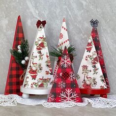 three wooden christmas trees are sitting on a table