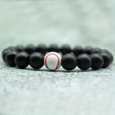 Elevate your style with our handmade basketball-beaded men's sports bracelet. Crafted with care and attention to detail, this bracelet is the perfect accessory for any sports enthusiast. Whether you're hitting the court or cheering on your favorite team from the sidelines, this bracelet is sure to make a statement. Made with high-quality materials, this bracelet is both durable and stylish. The intricate beadwork adds a unique touch to any outfit, while the elastic band ensures a comfortable fit. Whether you're wearing it during a game or out on the town, this bracelet is sure to turn heads. Key Features: 🏀 Show your love for basketball with this stylish bracelet🎁 It makes a great gift for men, sports enthusiasts, or basketball teams⚙️ Handmade with high-quality materials for durability Sporty Beaded Bracelets For Sports Events, Adjustable Black Tennis Bracelet For Gift, Adjustable Black Tennis Bracelet As Gift, Sporty Bracelets With Round Beads For Sports Events, Black Round Jewelry For Streetwear, Casual Round Beads Bracelets For Sports Events, Adjustable Black Jewelry For Sports, Adjustable Sporty Wristband For Sports, Black Team Spirit Adjustable Beaded Bracelets