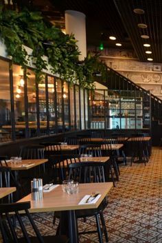 the inside of a restaurant with tables and chairs