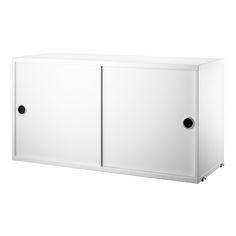 a white cabinet with two doors and black handles