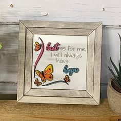 a frame with some flowers and a plant in it next to a sign that says, best as for me i will always have love you