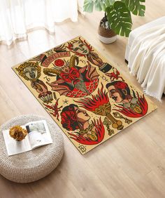 a living room area with a large rug on the floor and an open book next to it