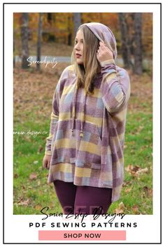 a woman standing in the grass wearing a purple and yellow plaid sweater with hoodie