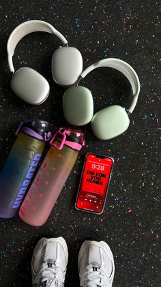 headphones, water bottle and mp3 player laid out on the floor next to each other