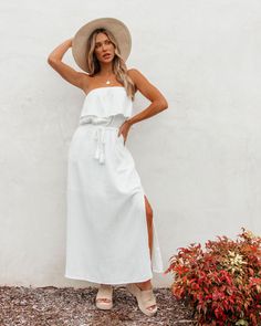 Our best White Tube Maxi Dress for the summer is here! Our White Strapless Ruffled Maxi Dress is a chic and stylish piece perfect for summer days! Features a tube top style that provides a sleek and minimalist silhouette! It's adorned with delicate ruffle detailing along the neckline, adding a playful and romantic touch. The tassel tie waist allows you to cinch in the dress for a flattering and adjustable fit. Style with sandals and a wide-brimmed hat for a stylish and comfortable beach look! Tube Maxi Dress, Tube Maxi Dresses, White Tube, Minimalist Silhouette, Brimmed Hat, Silhouette Free, Summer Is Here, Ruffled Maxi Dress, Beach Look