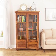 a living room with a couch, chair and bookcase