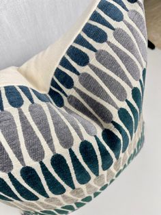 a close up of a chair cushion with blue and white designs on it's back