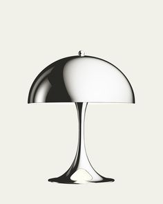 an image of a table lamp that is white and chromed on the base with a black dome shade