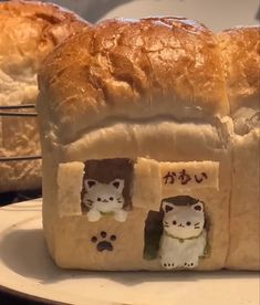 bread shaped like cats and kittens with writing on them