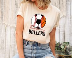 Busy Raising Ballers Shirt, Baseball Mom Shirt, Game Day Shirt, Shirt for Women, Baseball Mom Shirt, Soccer Mom Shirt, Basketball Mom Shirt  ORDER INSTRUCTIONS  ➤ Check and review all listing photos. ➤ Pick up your item's size and color from drop down menus. ➤ Choose the quantity. ➤ Click "Add to Cart" button. ➤ Fill in the personalization box as recommended if provided.  ➤ You can go back to add more item or you can complete the checkout process. ➤ Click "Proceed to Check Out".  WHICH SIZE FITS Soccer And Baseball Mom Shirt, Busy Raising Ballers Shirt, Busy Raising Ballers, Baseball Fan Shirts, Raising Ballers, Basketball Mom Shirts, Sport Mom, Baseball Mom Shirt, Sports Mom Shirts