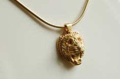 "18K gold plated \"Assyrian Lion\" pendant with a chain. Design is a tribute to bas reliefs of an ancient civilization. Total weight: 0.7 oz Dimensions: 0.8\"x1.16\"x0.43\" Chain length: 17.5\" Made in New York City Please write a message if you would like this necklace in silver or with stones. Customized orders usually take 10 business days to complete. US: Ships by USPS Priority Mail with insurance and signature confirmation. Delivery time is approximately two business days." Luxury Carved Yellow Gold Necklaces, Luxury Carved Gold Necklace, Gold Carved Necklace For Formal Occasions, Lion Head Necklace, Ancient Civilization, Lion Necklace, Lion Pendant, Head Necklace, Gold Lion