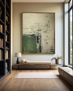 a large painting hanging on the wall above a bed in a room with wooden floors