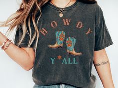 Howdy y'all! This is a Comfort Colors Shirt with a western, country vibe. Cowgirls are the cutest! Comfort Colors introduces its garment-dyed t-shirt; a fully customizable tee made 100% with ring-spun cotton. The soft-washed, garment-dyed fabric brings extra coziness to your wardrobe while the relaxed fit makes it an excellent daily choice. The double-needle stitching throughout the tee makes it highly durable while the lack of side-seams helps the shirt retain its tubular shape. .: 100% ring-spun cotton .: Medium fabric (6.1 oz/yd² (206.8 g/m .: Relaxed fit .: Sewn-in twill label Country Style Tops For Fall Country Events, Country Style T-shirt For Rodeo In Fall, Retro Fall Rodeo T-shirt, Western Letter Print Tops For Country Events, Western Tops With Letter Print For Country Events, Western Style Tops With Letter Print For Country Events, Western Style Top With Letter Print For Country Events, Casual Tops For Country Events In Fall, Fall Graphic Print T-shirt For Country Events