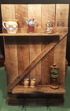 a wooden shelf with some vases and other items on it's side,