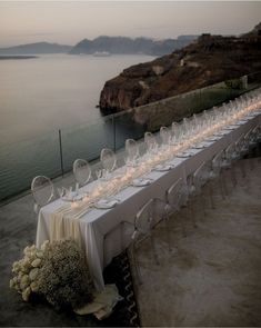 a long table is set with wine glasses and candles