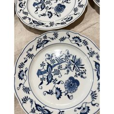 two blue and white plates sitting on top of a table