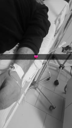 a man sitting in a hospital bed next to a pink heart