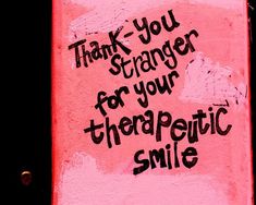 a pink sign with the words thank you, strange for your theatre smile on it