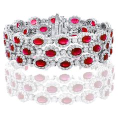 A beautiful Ruby and Diamond 3-row bracelet showcasing color-rich Rubies, surrounded by a single row of brilliant round diamonds. 42 Oval cut lush red rubies weigh 18.01 carats total; 420 accent diamonds weigh 16.44 carats total. Made in 14k white gold. Style is available in different price ranges. Prices are based on your selection. Please contact us for more information.